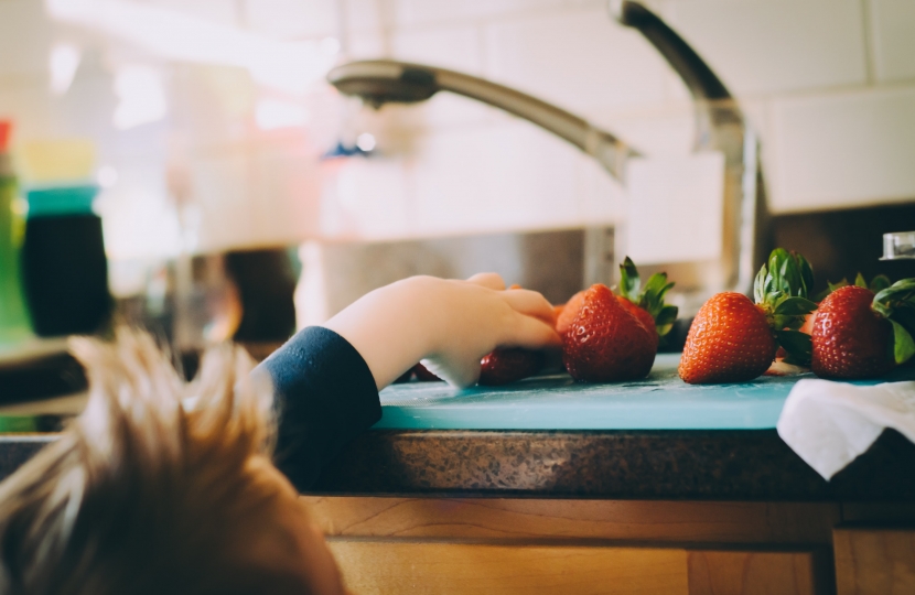 Image: child reaching for strawberries